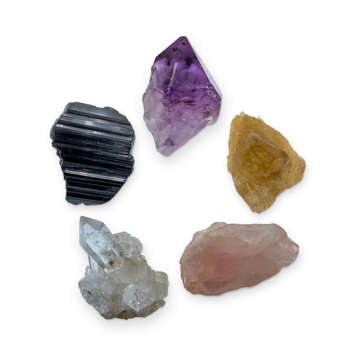 Beginner Crystal Kit: amethyst point, natural citrine, rose quartz, clear quartz cluster and black tourmaline, shown together on white