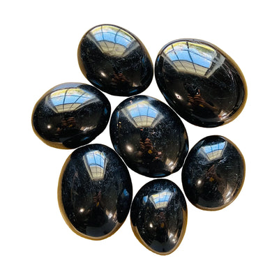 Black tourmaline palm stone, AA grade, Madagascar origin, hero view.