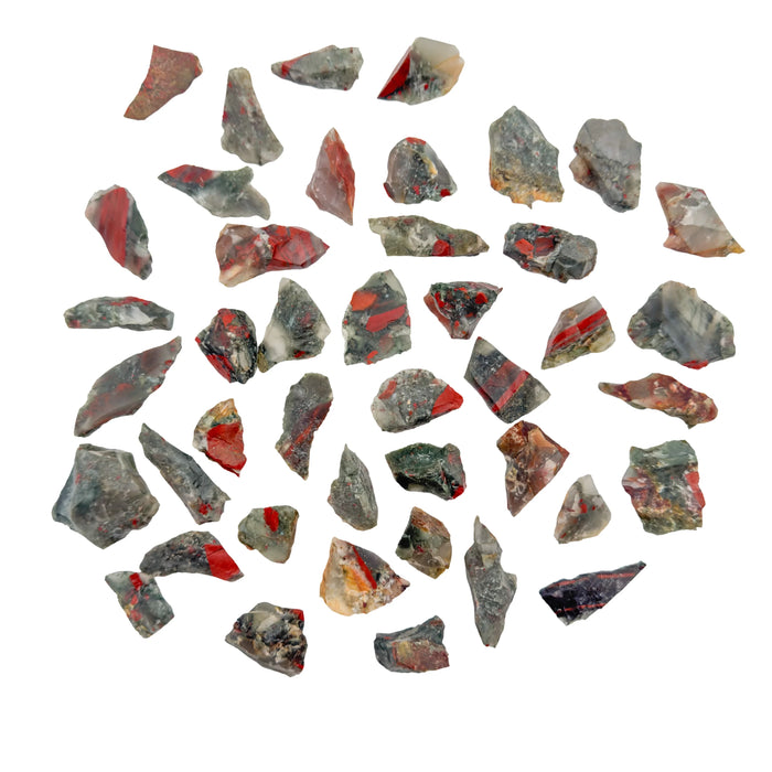 Green and red Bloodstone raw stones, AA grade from Eswatini, scattered on white