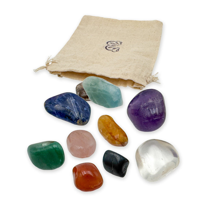 Large Brazilian tumbled stone set: ten polished stones in front of the reusable cotton bag they ship in, on white
