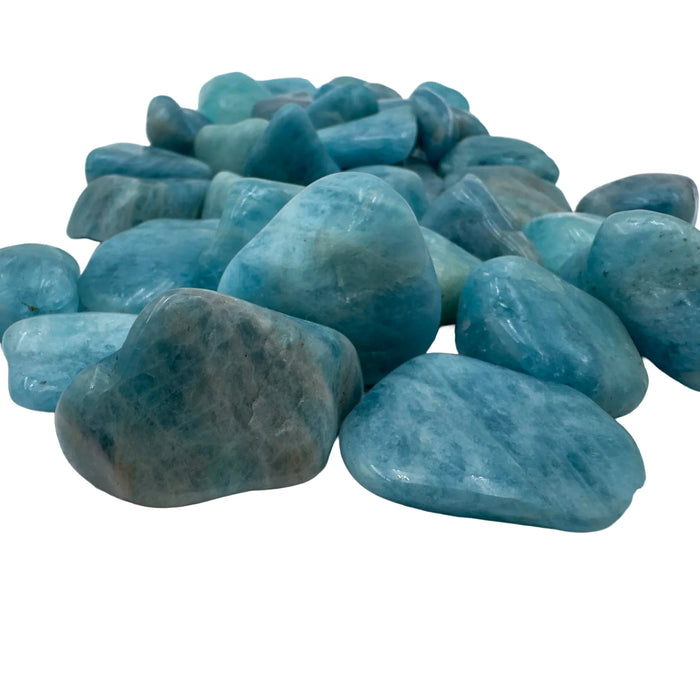Side profile of Aquamarine tumbled stone, showing translucent edges.