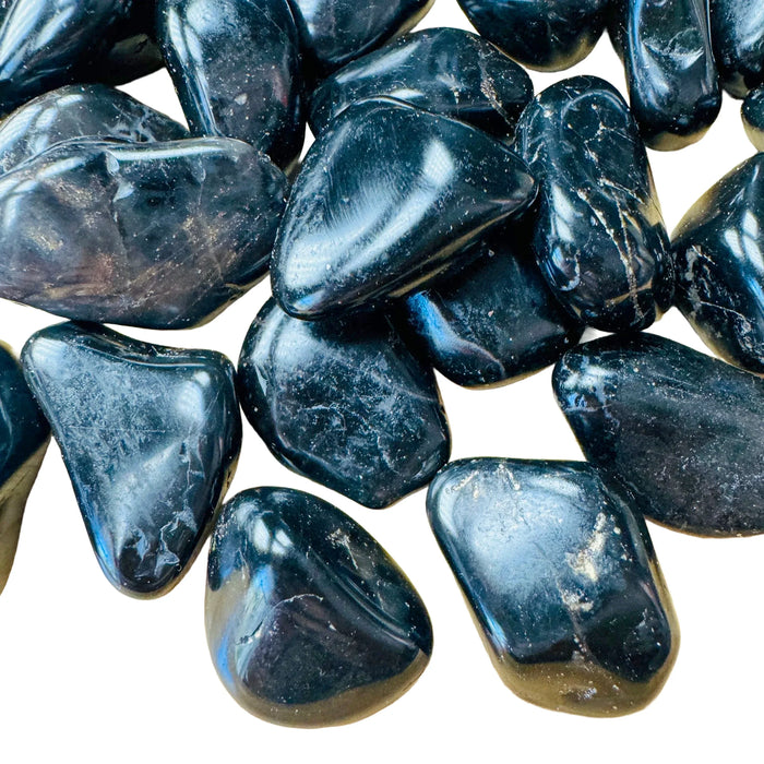 Up-close view of Grade AA Black Onyx tumbled stone, from Brazil, showing subtle veining.