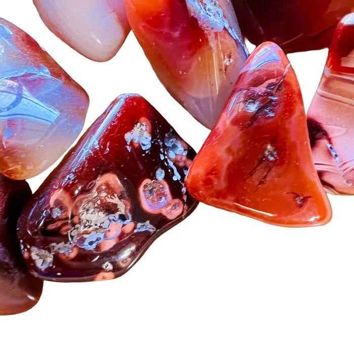 Rear view of orange Carnelian tumbled stone, from Boeny, Madagascar, showing color depth.