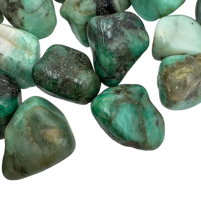 Bird's-eye view of Emerald tumbled stone, sourced from Brazil, showing characteristic patterning.