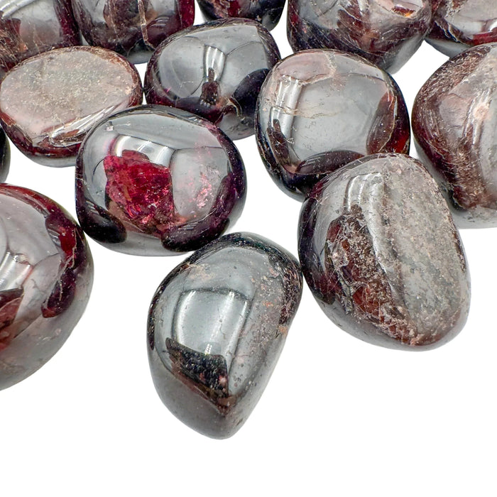 Sideways view of Garnet tumbled stone, showing soft luster, Malawi-sourced.