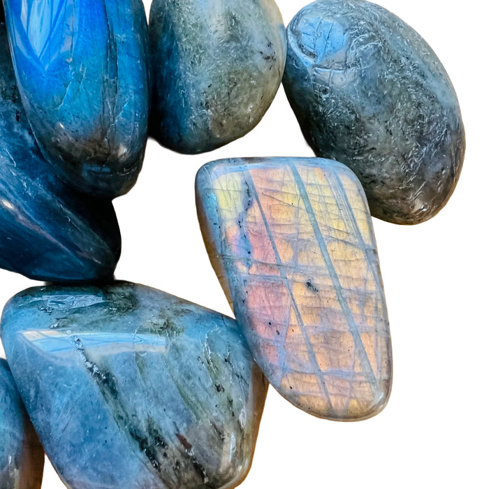 Side-on view of Labradorite tumbled stone, from Madagascar, showing matte finish.