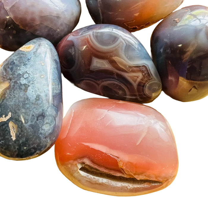 Detail of Red Agate palm stone, showing natural inclusions, often paired with practices around Grounding.