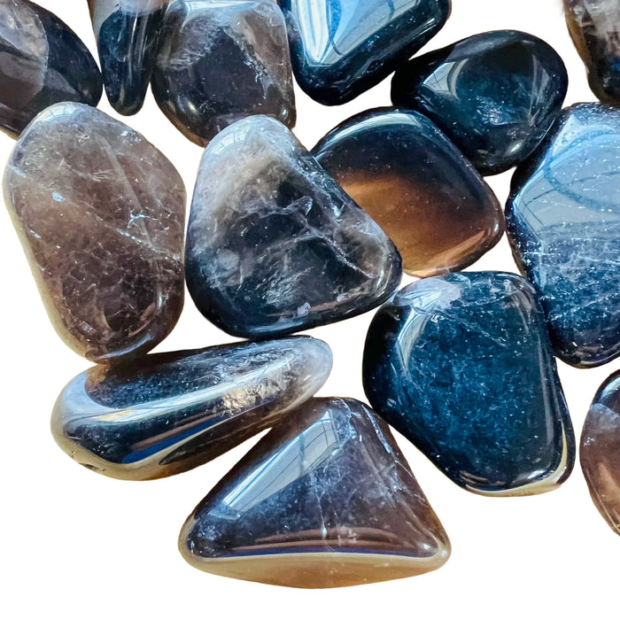 Macro view of Smoky Quartz tumbled stone, sourced from Vakinankaratra, Madagascar, traditionally used for Grounding.