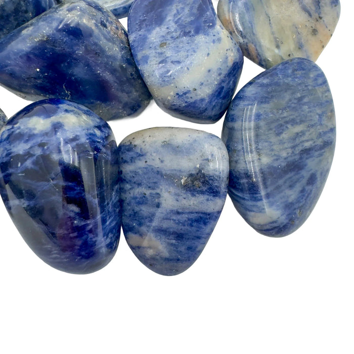 Sideways view of Sodalite tumbled stone, traditionally used for Focus and Intuition.