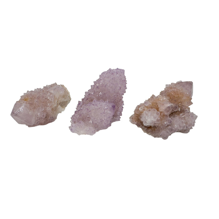 Three AA grade Cactus Spirit Quartz points from Mpumalanga, South Africa, laid side by side on white to show the 0.50 to 1.25 inch size range.