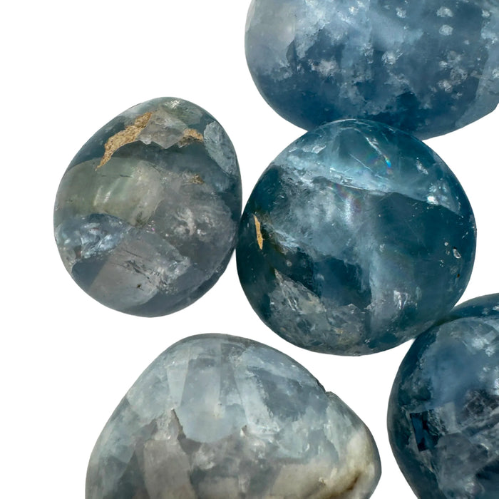 Held in hand, a Celestite palm stone kept close for Stress Relief.