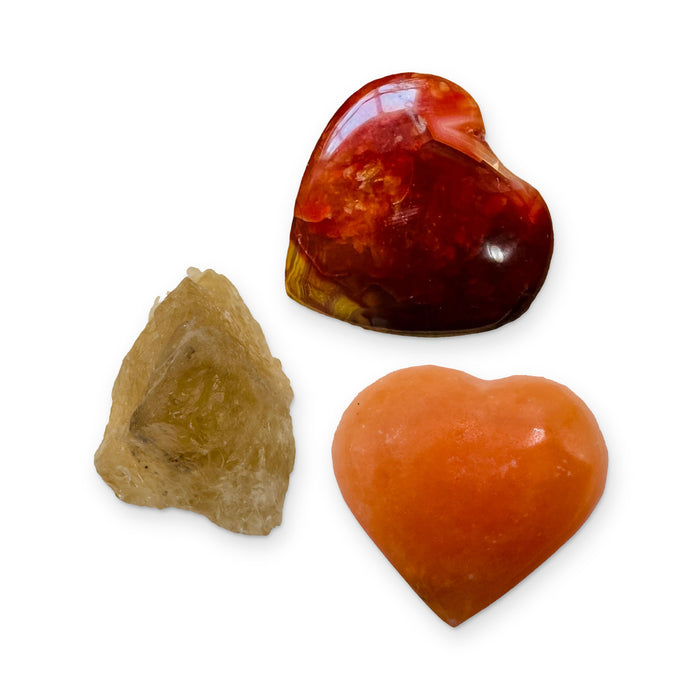 Creativity Crystal Kit: carnelian heart, orange calcite heart and natural citrine, shown together on white