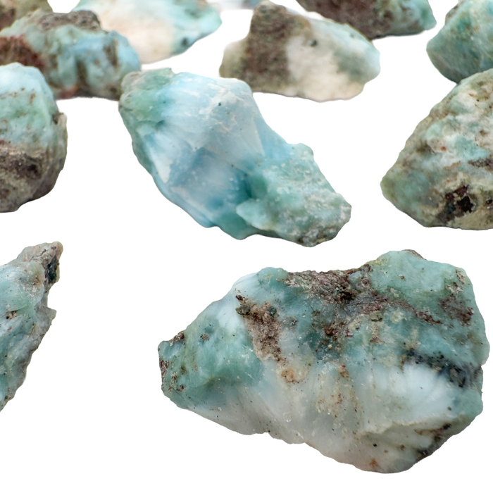 Close view of Larimar raw stones showing sea blue color with white pectolite veining, A grade Dominican Republic