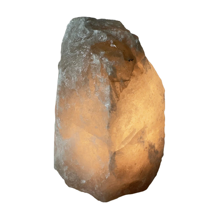 Smoky quartz crystal lamp glowing, warm light passing through the stone
