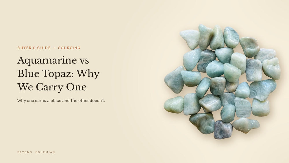 Aquamarine tumbled stones isolated on a warm linen backdrop for a buyer's guide comparing aquamarine and blue topaz