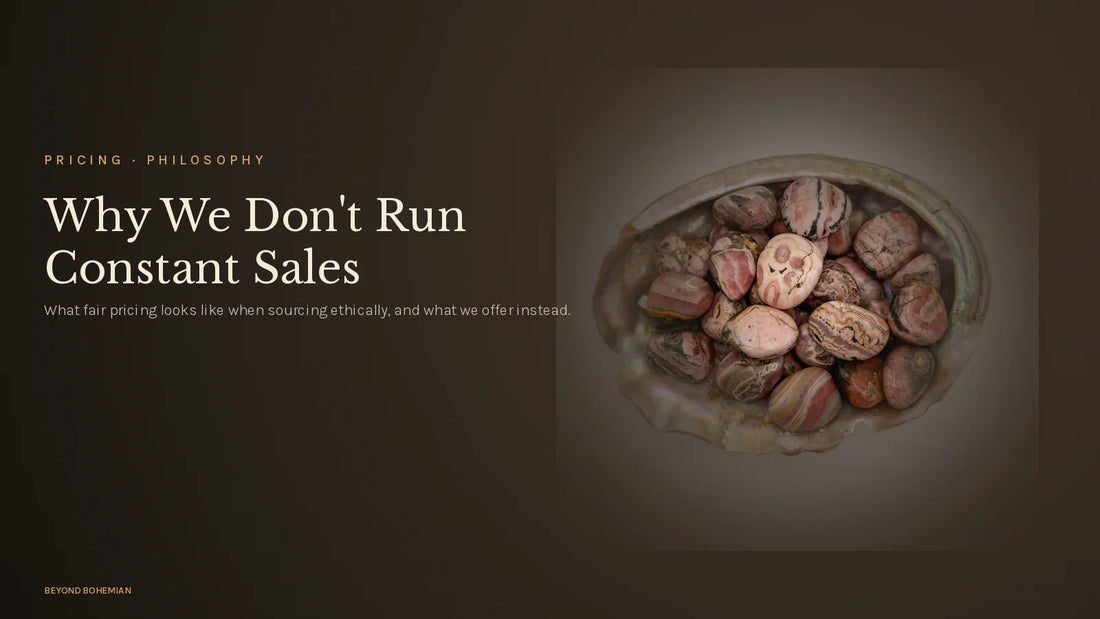 Tumbled rhodochrosite on dark moody backdrop for why we don't run constant sales article