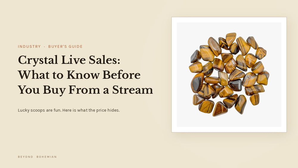 Tiger eye tumbled stones on a white tile against a warm linen backdrop for an article about crystal live sales