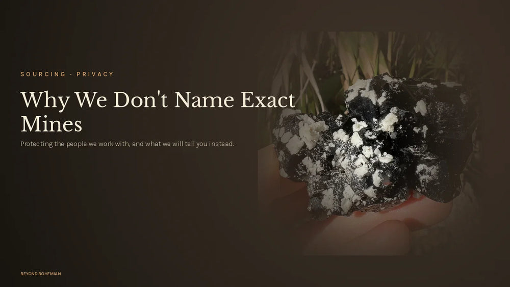 Raw black tourmaline crystal on dark moody backdrop for why we don't share mine locations article
