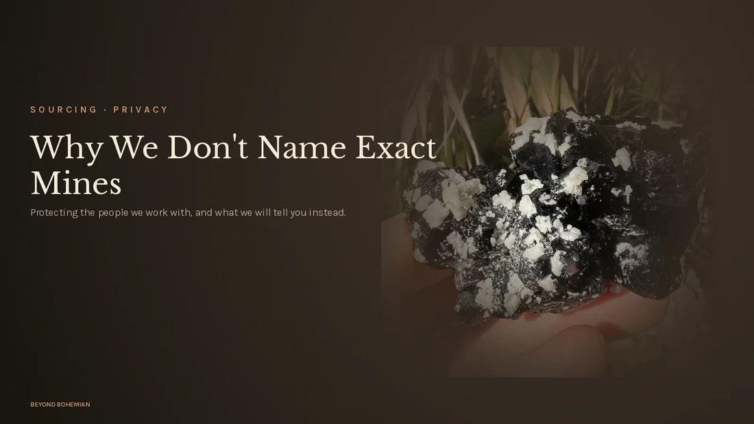 Raw black tourmaline crystal on dark moody backdrop for why we don't share mine locations article