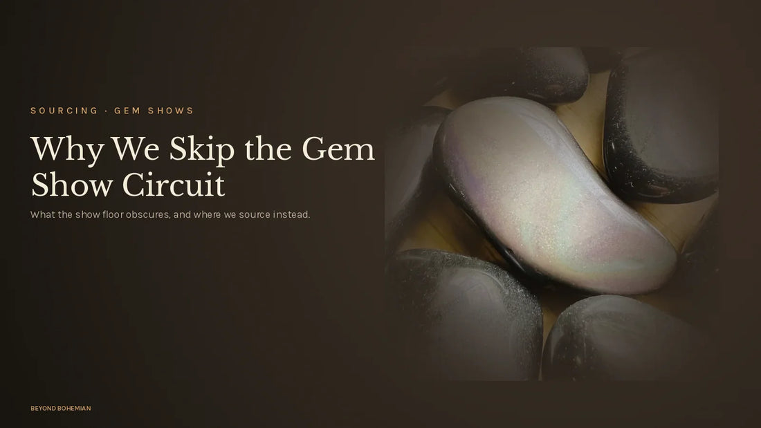 Rainbow obsidian stone on dark moody backdrop for why we don't source at gem shows article