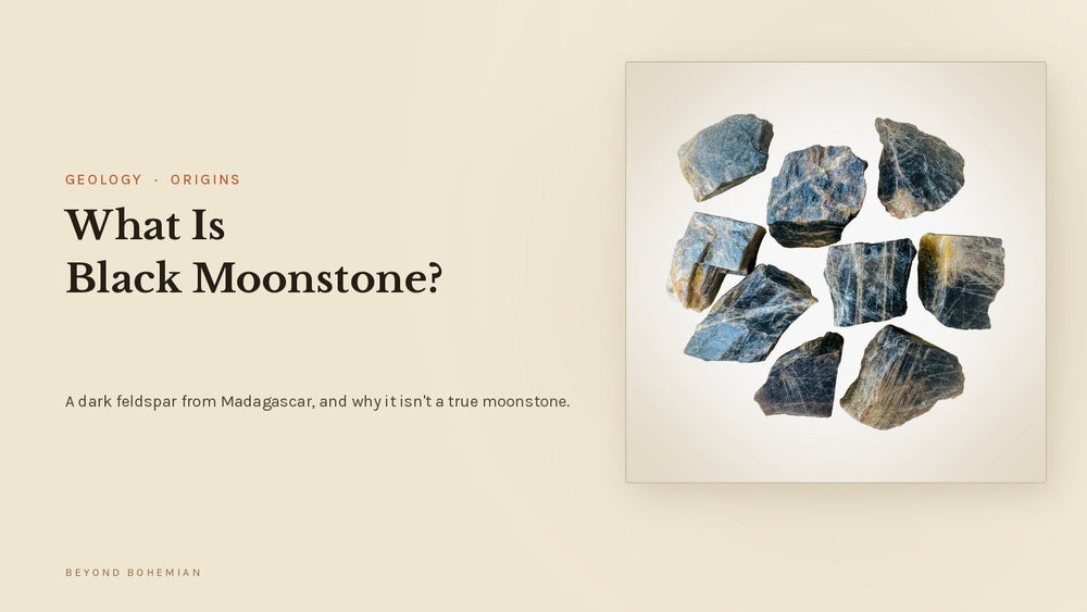 Raw black moonstone from Madagascar showing silver-blue flash, on a warm linen background, for an article on what black moonstone is