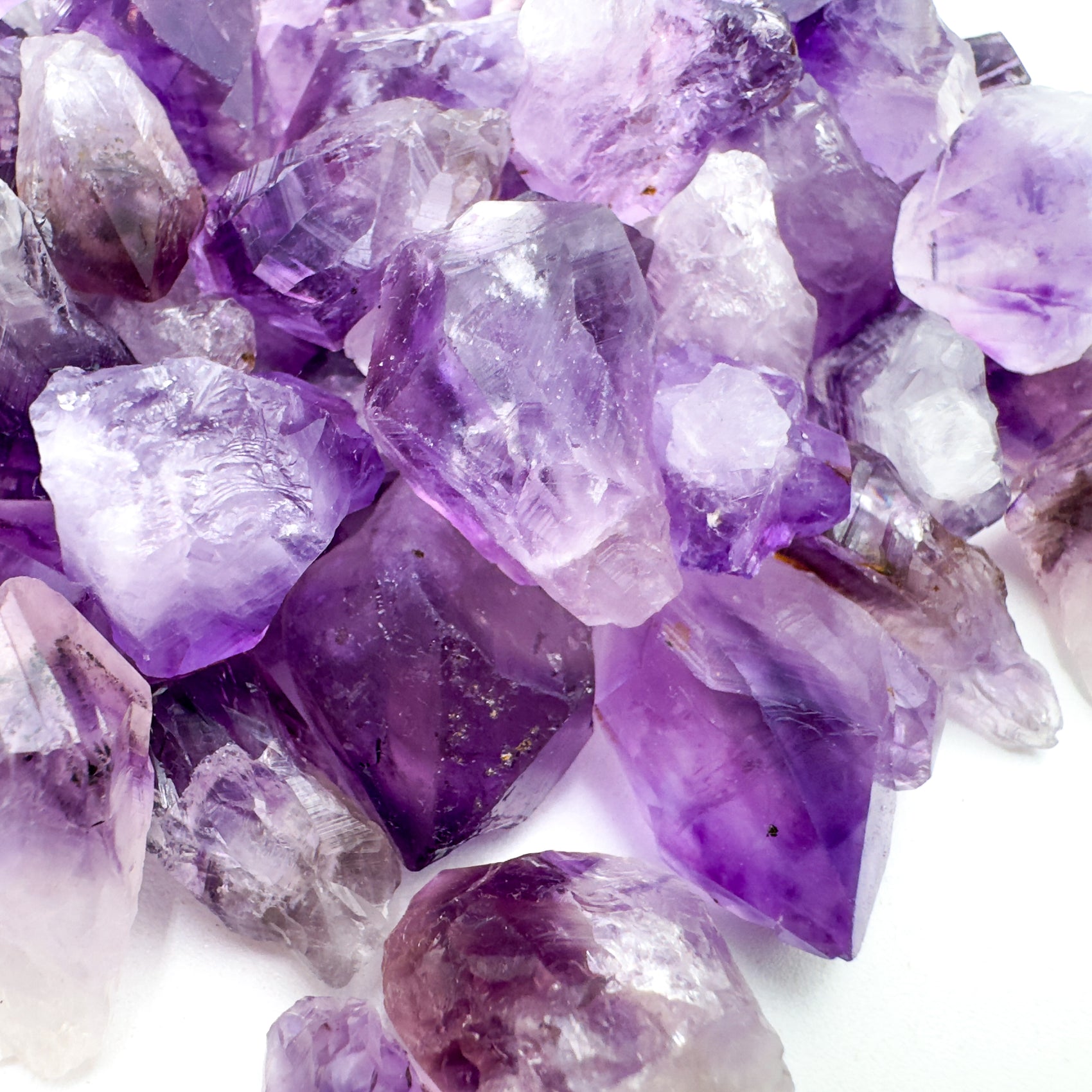Amethyst point showing internal color zoning and clear quartz base