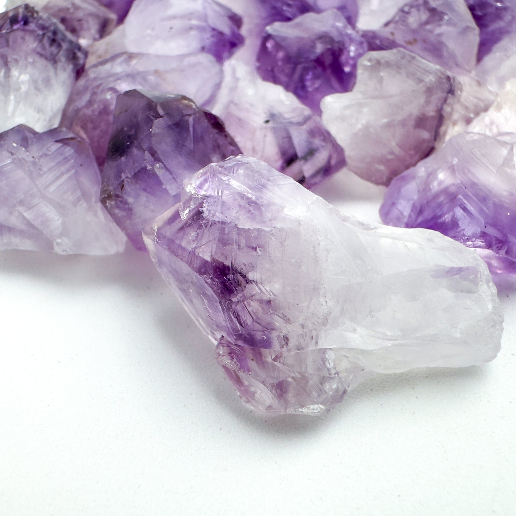 Close-up of Grade AA Amethyst raw point, showing natural texture.