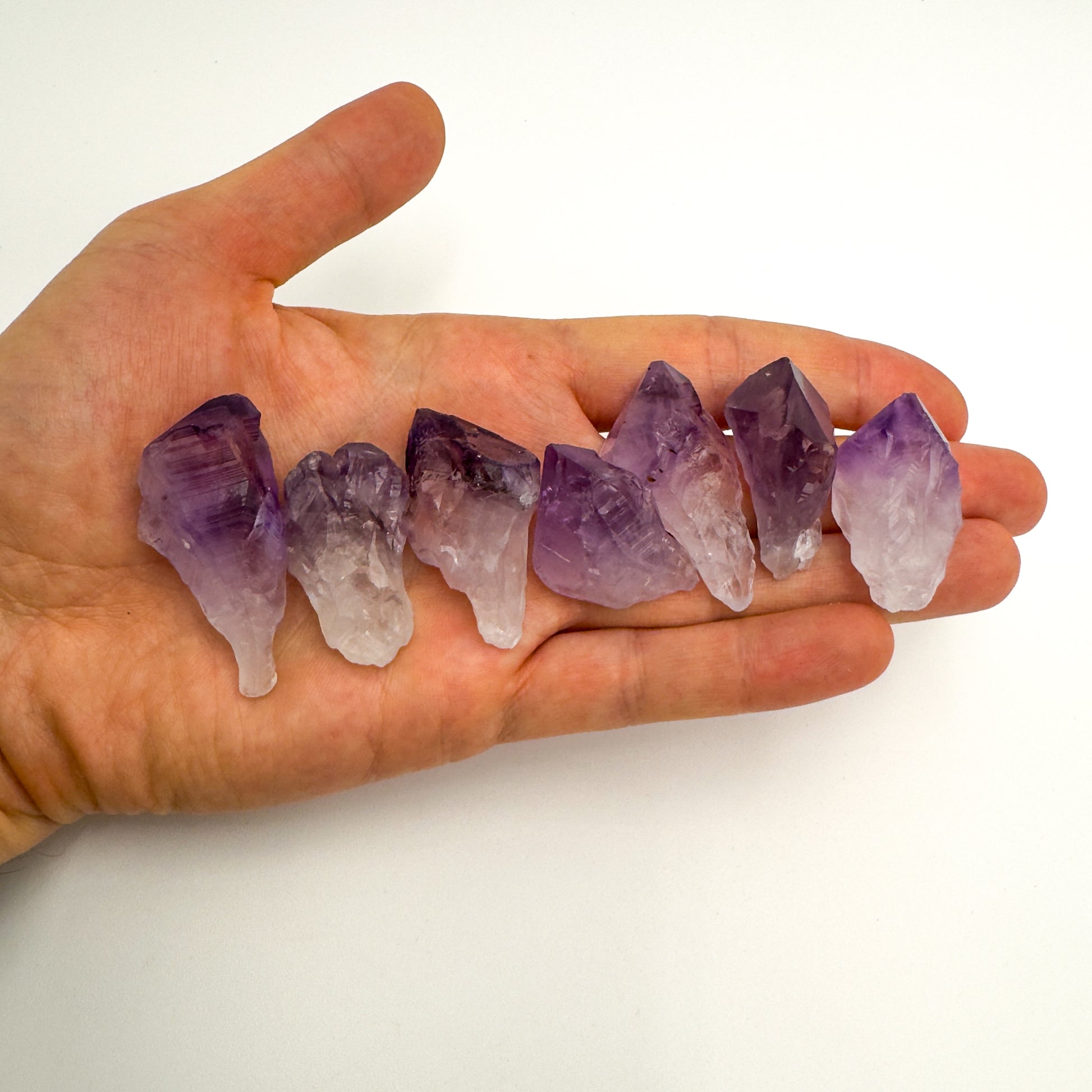Tabletop view of Amethyst raw crystal, from Rio Grande do Sul, Brazil, often kept for Meditation, shown in a calm studio setting.