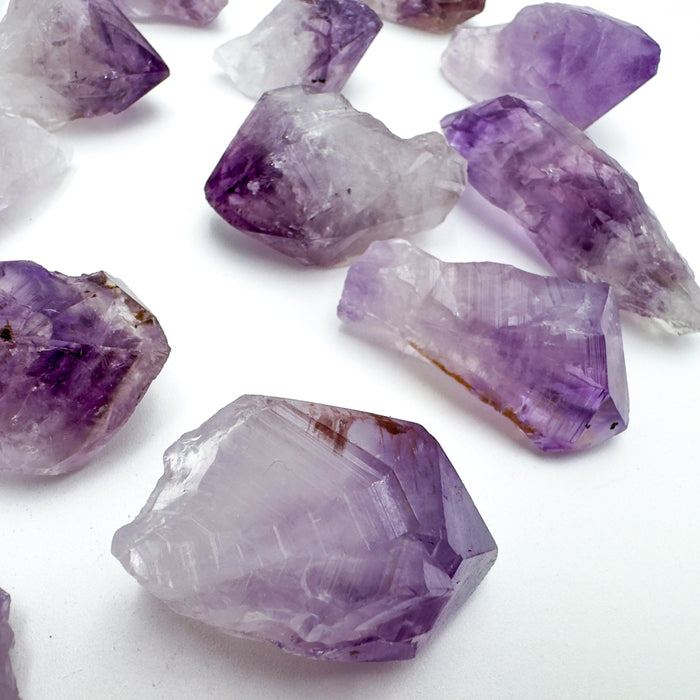 Edge-on view of Amethyst raw point, turned to for Stress Relief and Sleep.