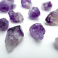 Top angle of Amethyst raw point, showing raw matrix.