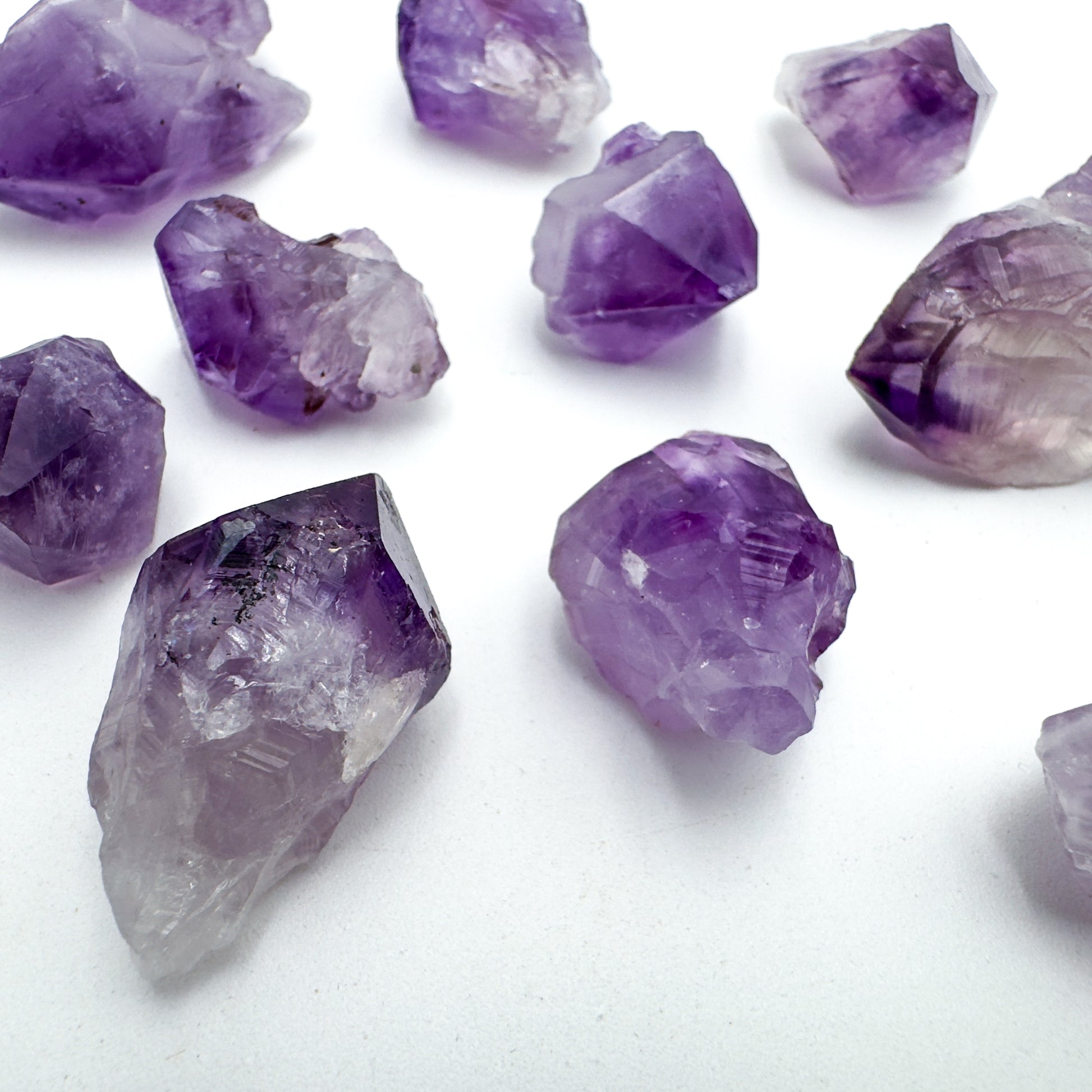 Top angle of Amethyst raw point, showing raw matrix.
