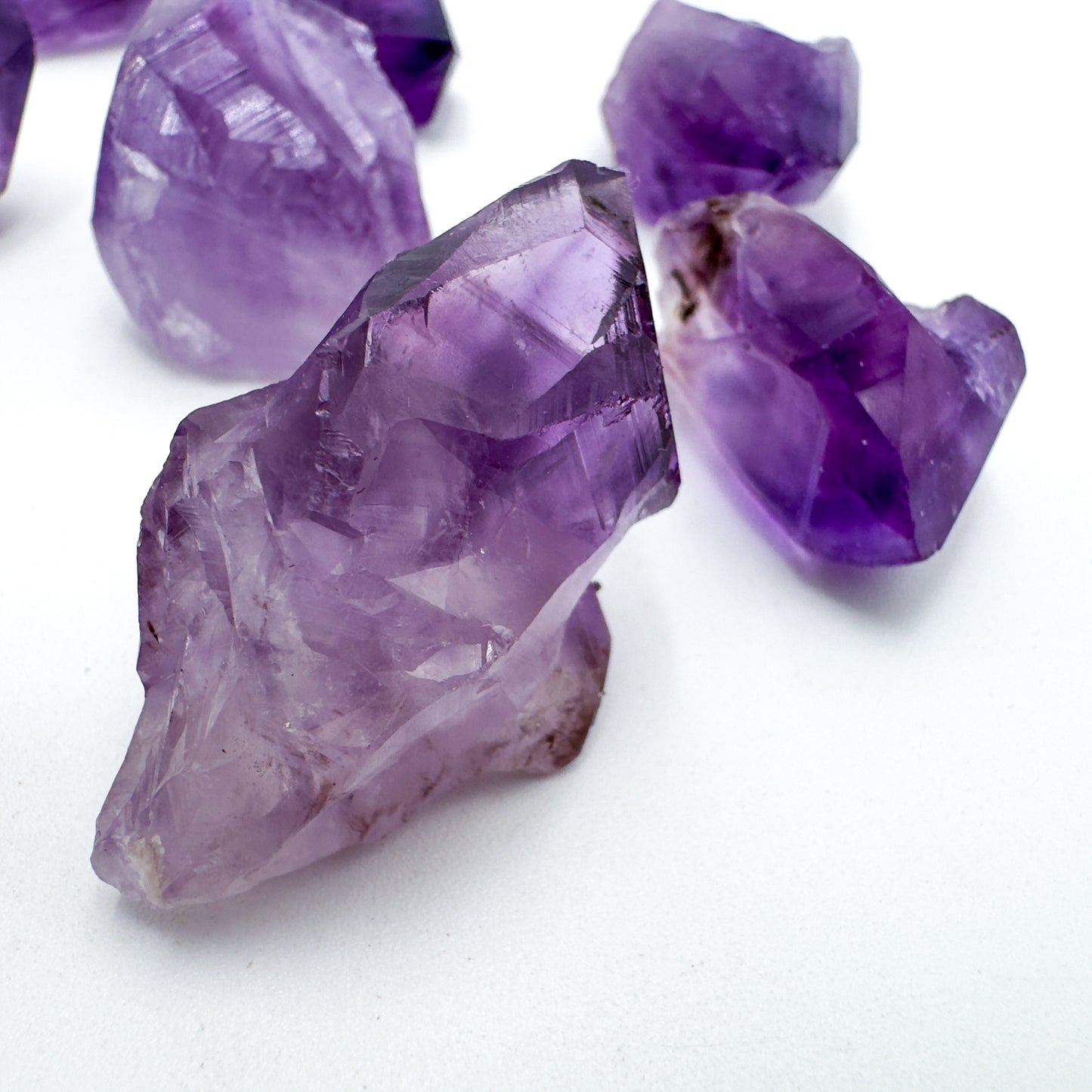 Scale reference of one Amethyst raw point for scale, sourced from Brazil.