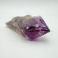Sideways view of Amethyst polished point, kept close for Stress Relief, showing earthy tone.