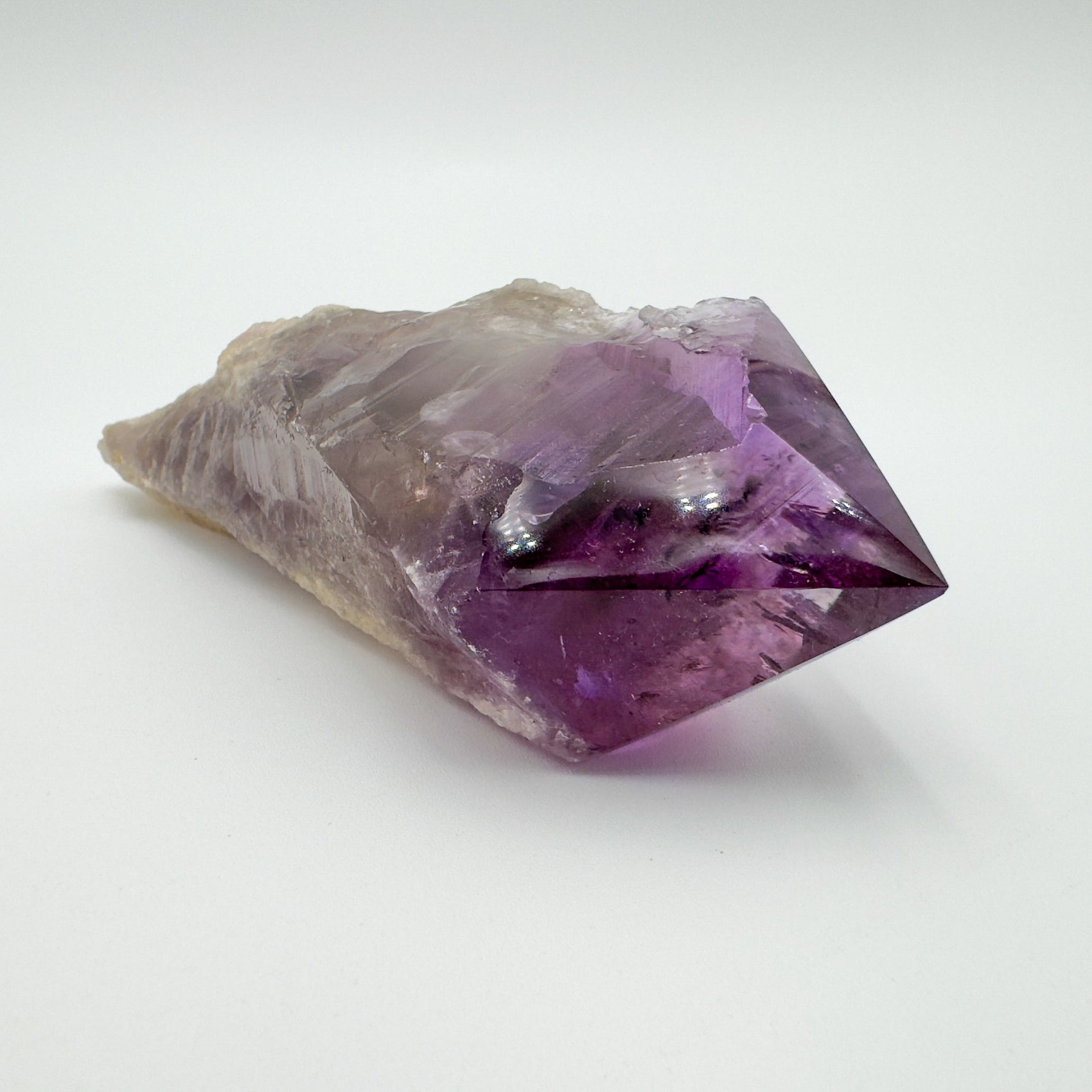 Sideways view of Amethyst polished point, kept close for Stress Relief, showing earthy tone.