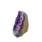 The angled three-quarter view of amethyst geode no. 102, 2.47 inches of violet druzy standing on a flat cut base.
