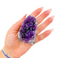 Cut base of a 0.37 pound amethyst geode, no. 102, deep purple crystal lining a polished grey agate rind.