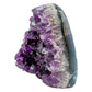 Uruguayan amethyst geode no. 105 at the angled three-quarter view, violet crystal interior framed by its polished agate shell, 0.72 lb.