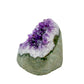 The angled three-quarter view of amethyst geode no. 109, 3.30 inches of violet druzy standing on a flat cut base.