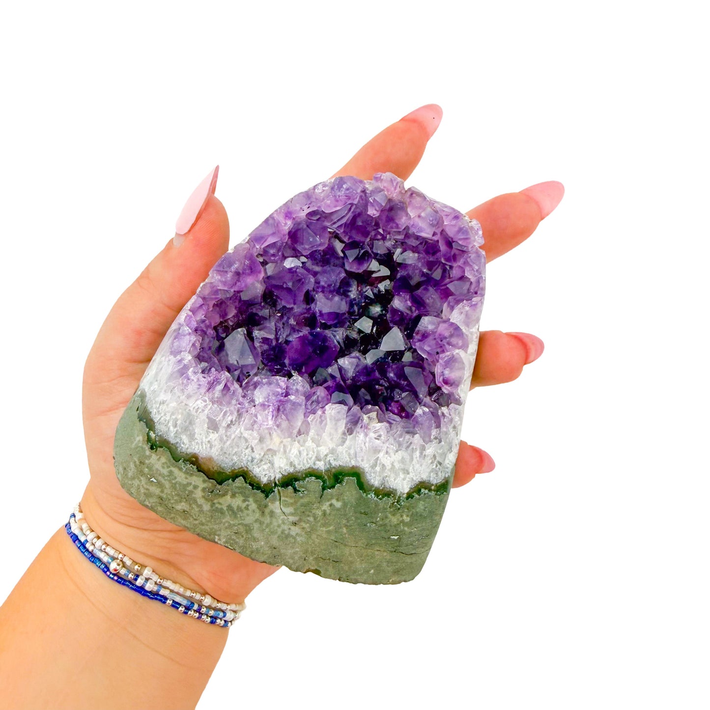 Cut base of a 1.28 pound amethyst geode, no. 109, deep purple crystal lining a polished grey agate rind.