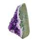 The angled three-quarter view of amethyst geode no. 116, 4.24 inches of violet druzy standing on a flat cut base.