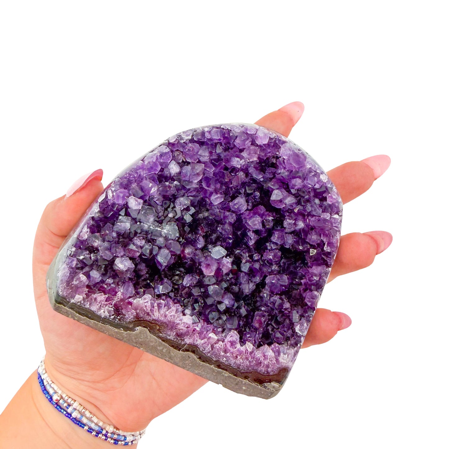 Polished amethyst geode no. 124 photographed at the cut base, measuring 4.00 by 1.97 by 3.57 inches, Uruguayan AA grade.
