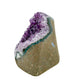 The angled three-quarter view of amethyst geode no. 130, 3.68 inches of violet druzy standing on a flat cut base.