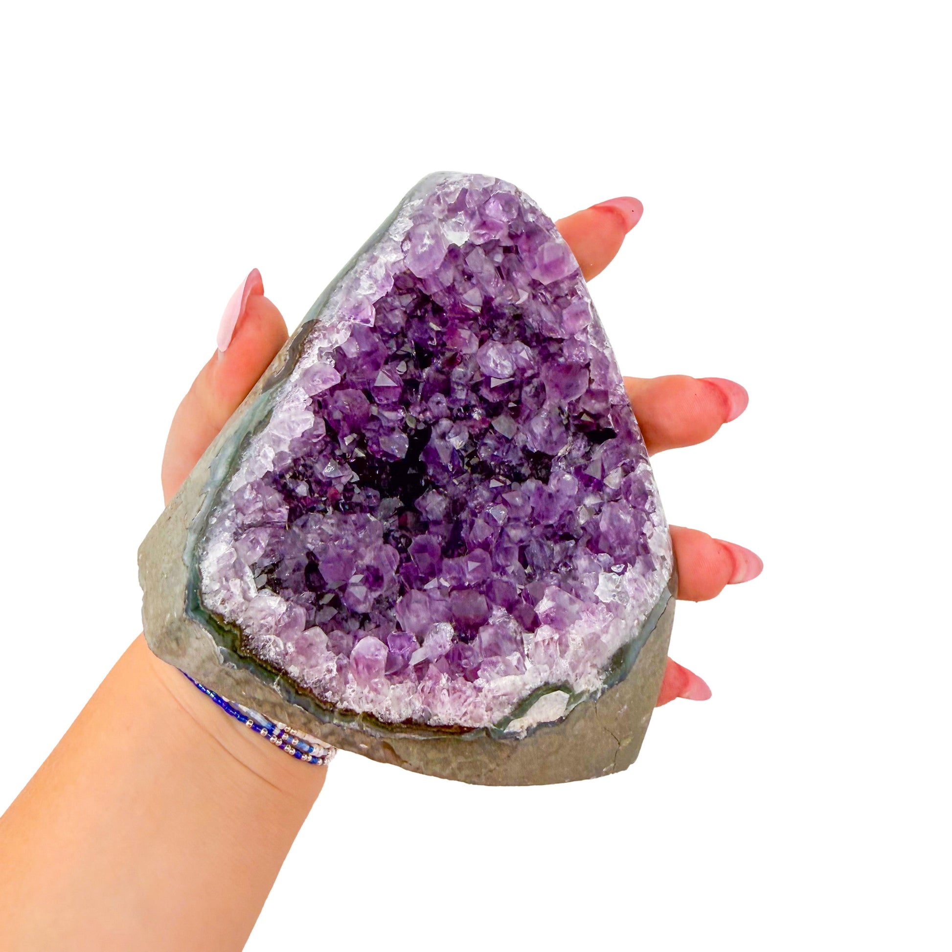 Cut base of a 1.96 pound amethyst geode, no. 130, deep purple crystal lining a polished grey agate rind.