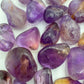 Top view of Ametrine tumbled stone, showing natural sheen, carried for Focus.
