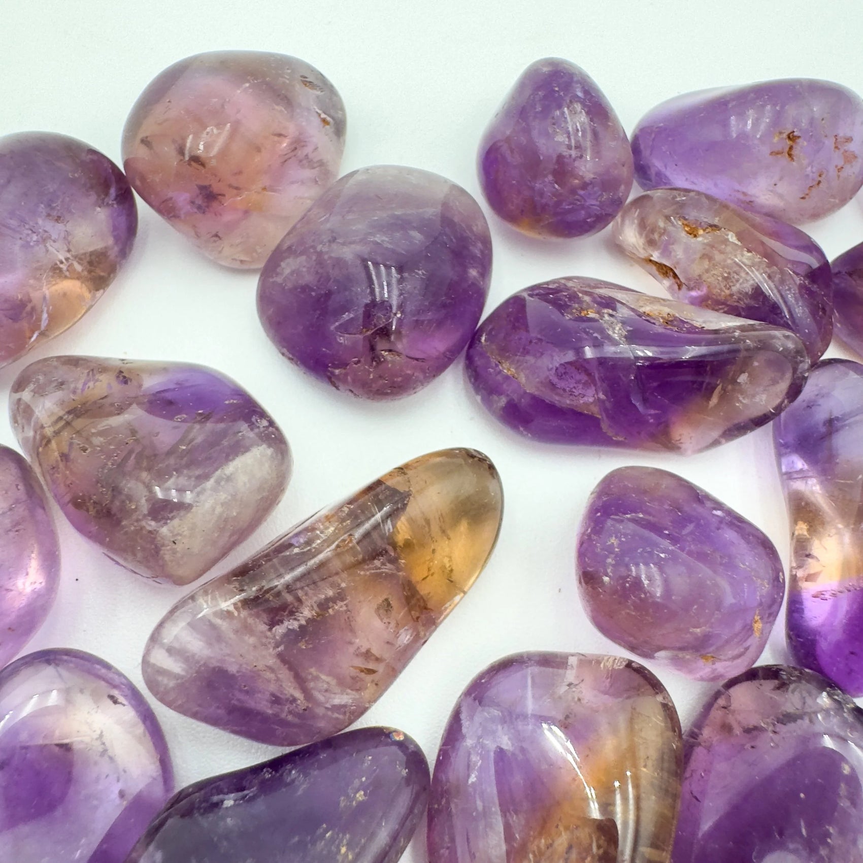 Close-up of Ametrine tumbled stone from Bolivia, soothing wellness stone for Abundance