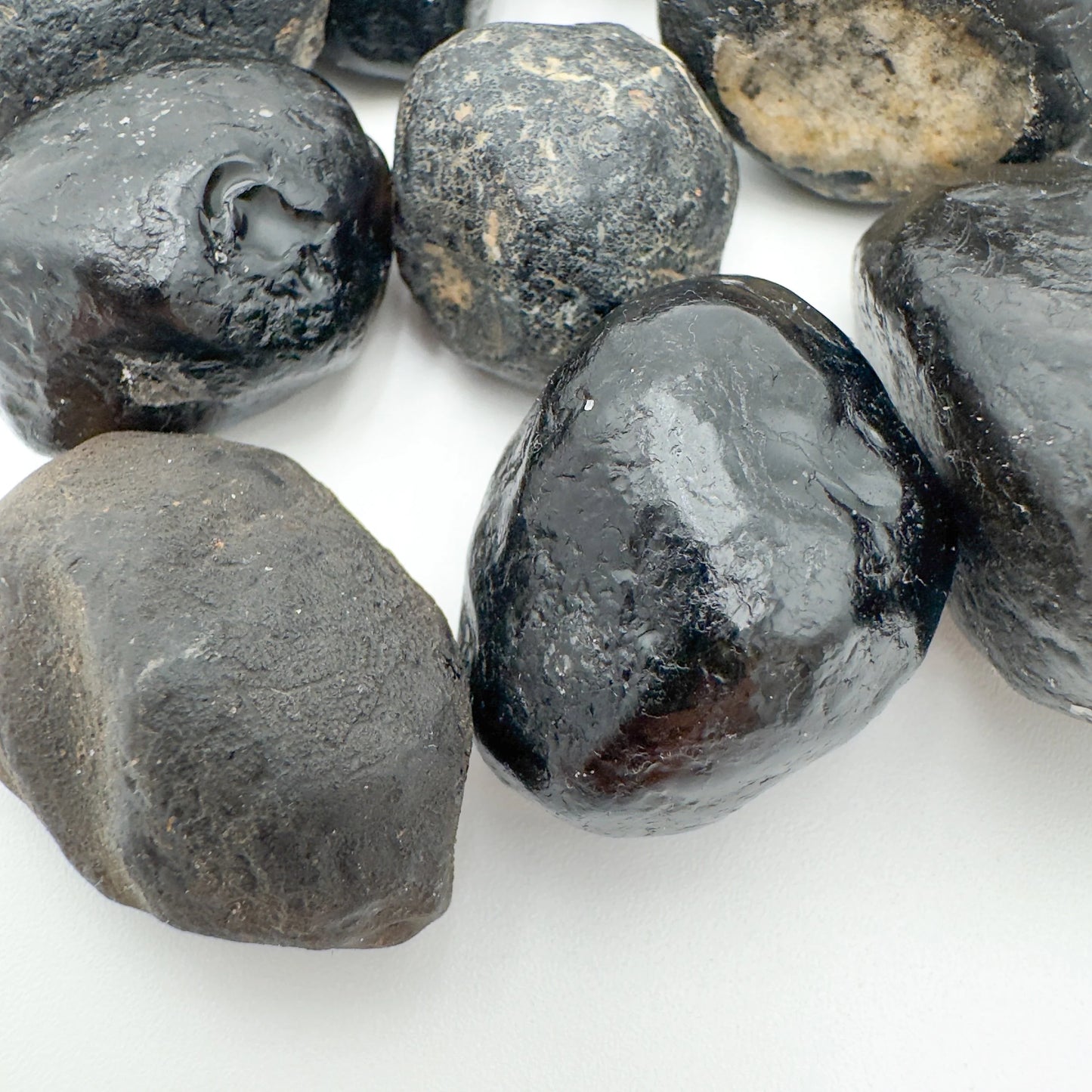 Top-side view of Apache Tear raw stone, showing natural color depth, hand-selected from Arizona, United States.