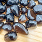 Overhead angle of Apache Tear tumbled stone, showing characteristic finish, often paired with practices around Grounding.