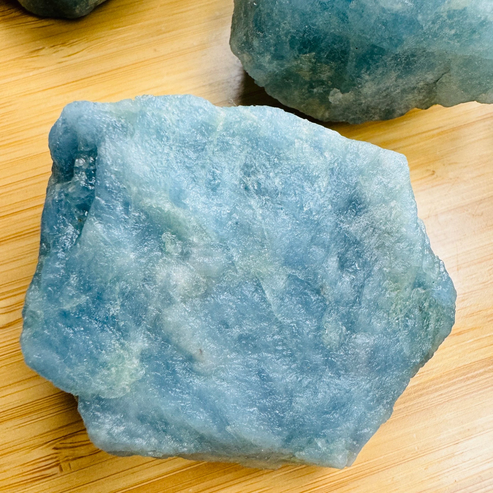 Daylight view of a single Aquamarine raw stone hand-selected from Minas Gerais, Brazil.
