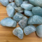 Edge-on view of Aquamarine tumbled stone, from Minas Gerais, Brazil, drawn on for Stress Relief and Emotional Healing.