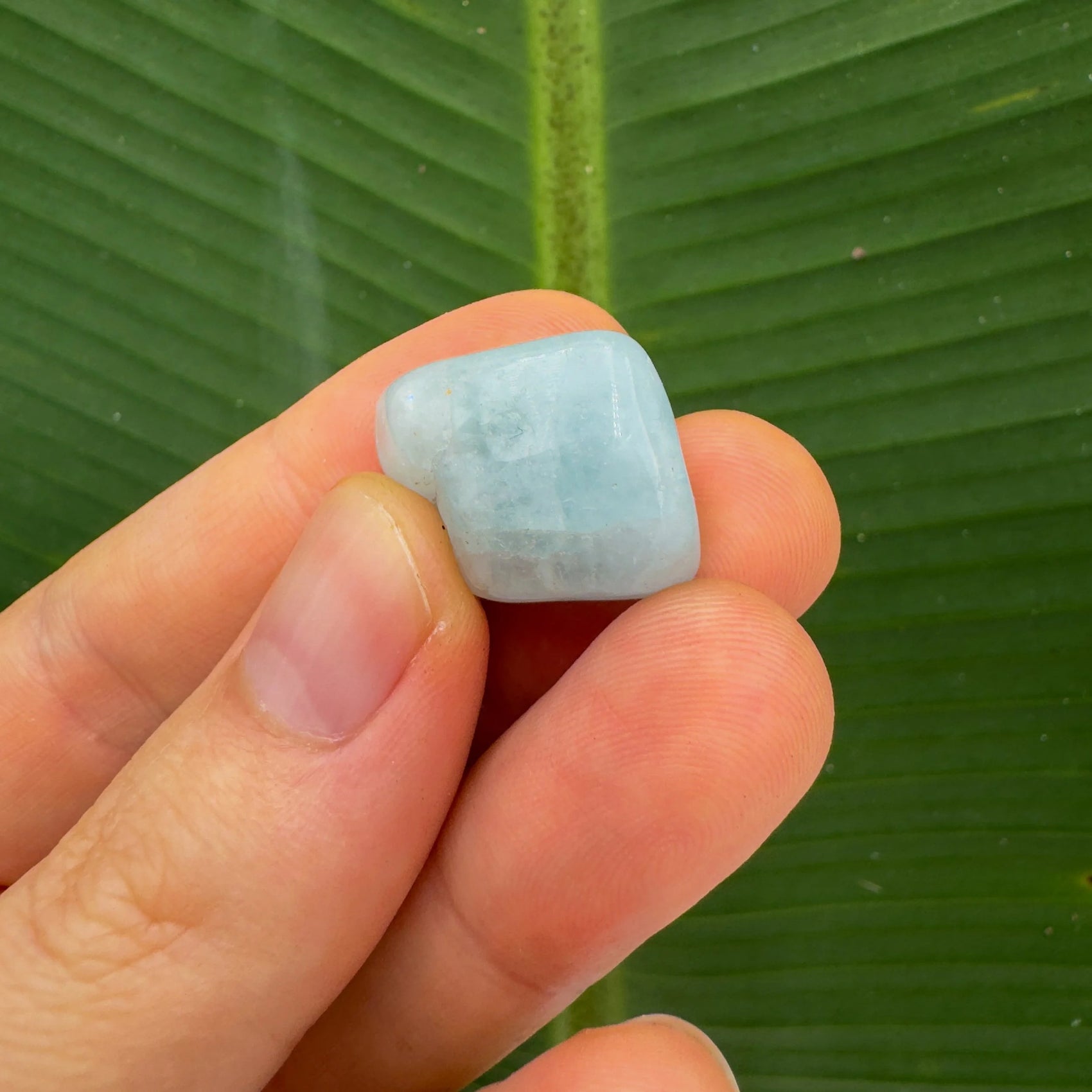 Back view of Grade A Aquamarine tumbled stone showing natural surface